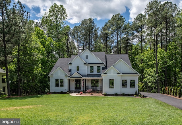 modern farmhouse featuring a front yard and a porch