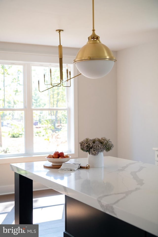 unfurnished dining area featuring a wealth of natural light, a chandelier, and breakfast area