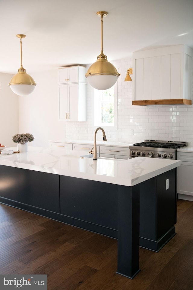 kitchen featuring dark wood-type flooring, pendant lighting, white cabinets, and decorative backsplash