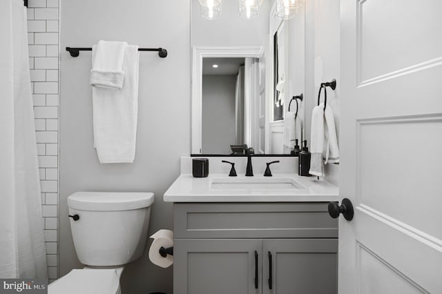 bathroom featuring vanity, a shower with shower curtain, and toilet