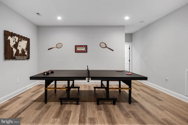 recreation room with wood-type flooring