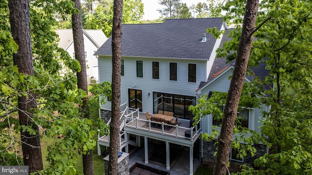 rear view of house featuring an outdoor hangout area and a deck