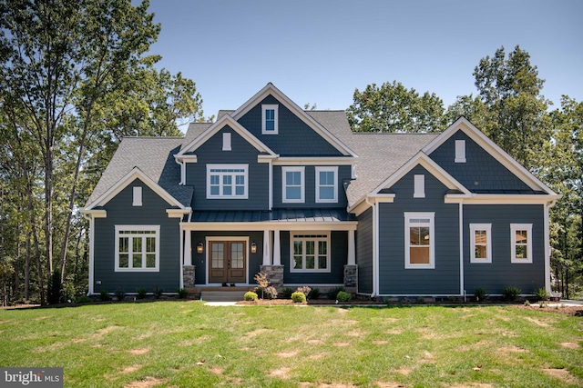 craftsman-style home with a front yard and french doors