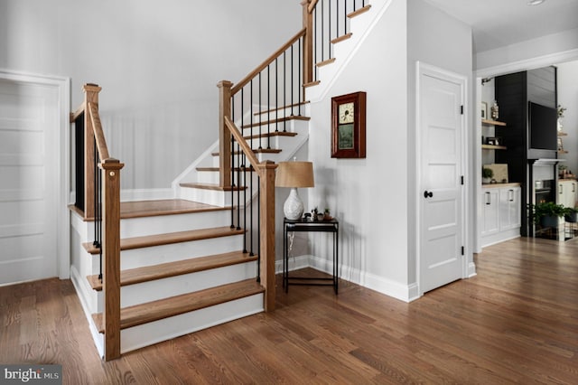 stairs with hardwood / wood-style flooring