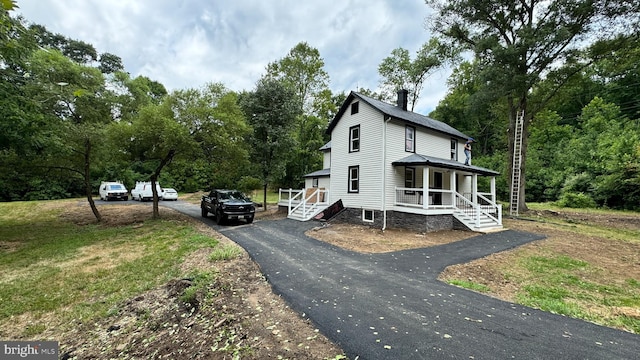 view of side of property with a porch