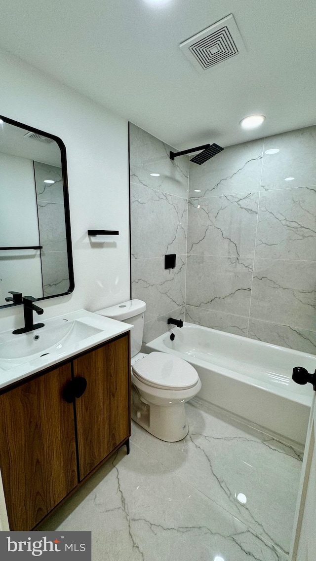 full bathroom with tile patterned floors, toilet, vanity, and tiled shower / bath