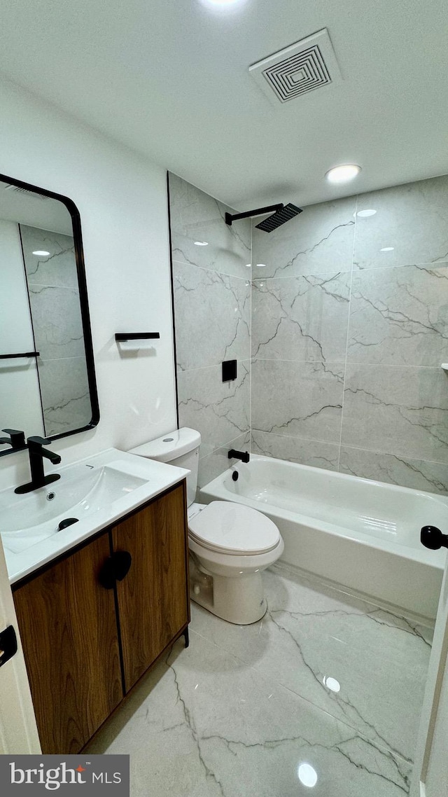 full bathroom with tiled shower / bath combo, tile patterned flooring, toilet, and vanity