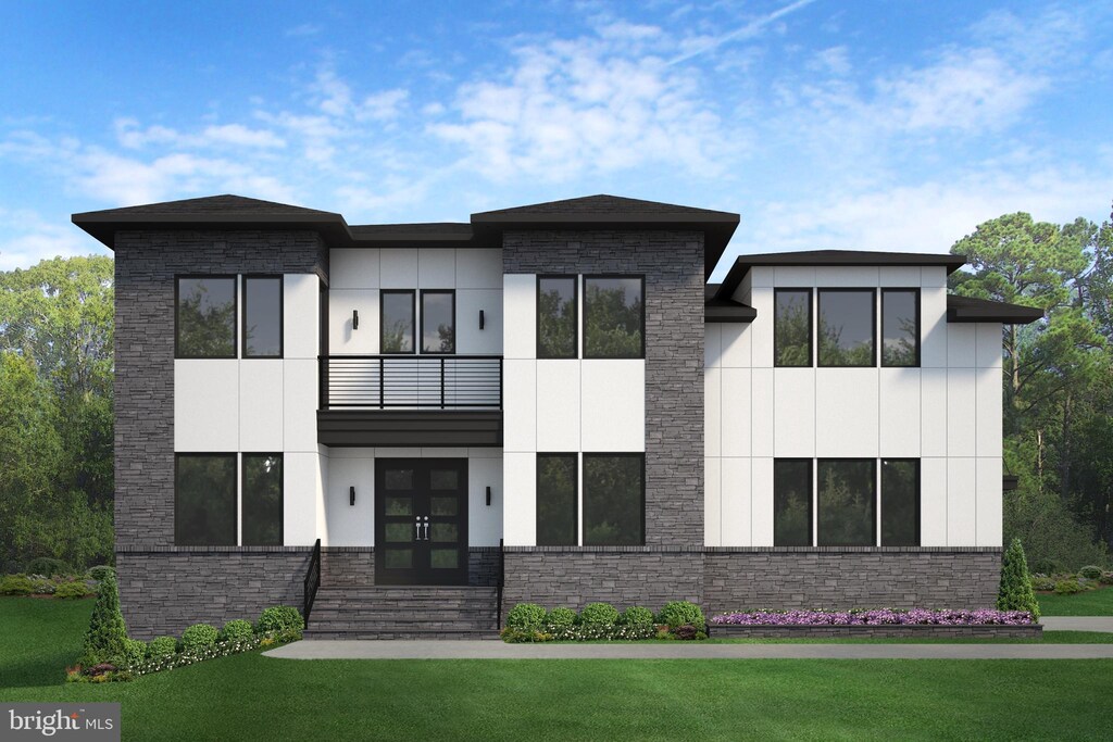 view of front facade with a front lawn, french doors, and a balcony