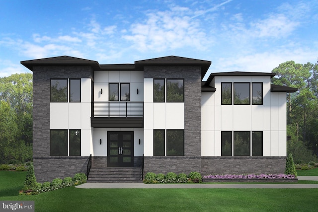 view of front facade with a front lawn, french doors, and a balcony