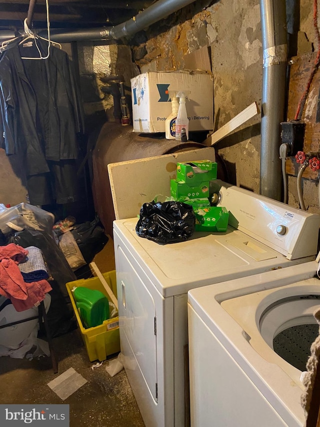 clothes washing area featuring washer and clothes dryer