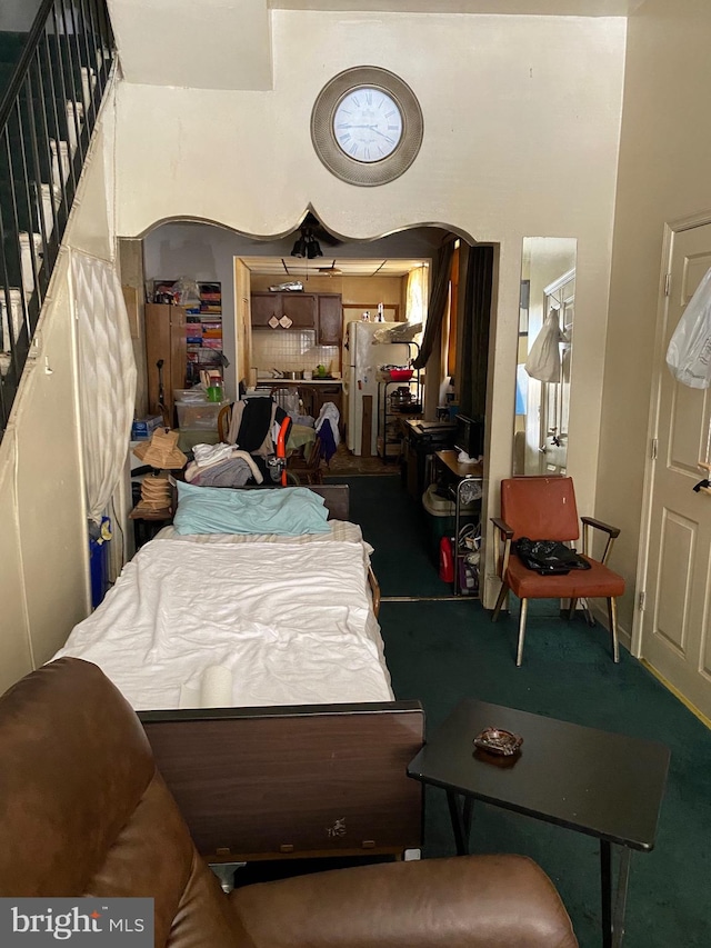 bedroom featuring white refrigerator and carpet