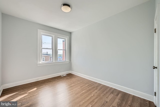 unfurnished room featuring wood-type flooring