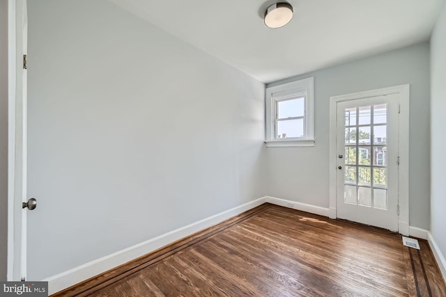 spare room featuring dark hardwood / wood-style flooring