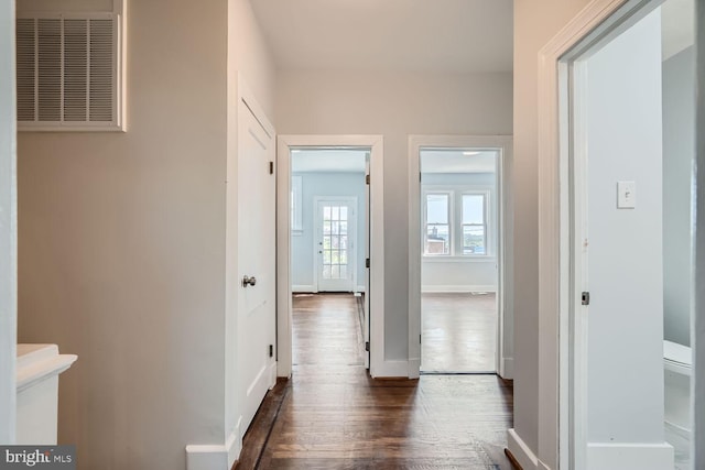 hallway with dark hardwood / wood-style flooring