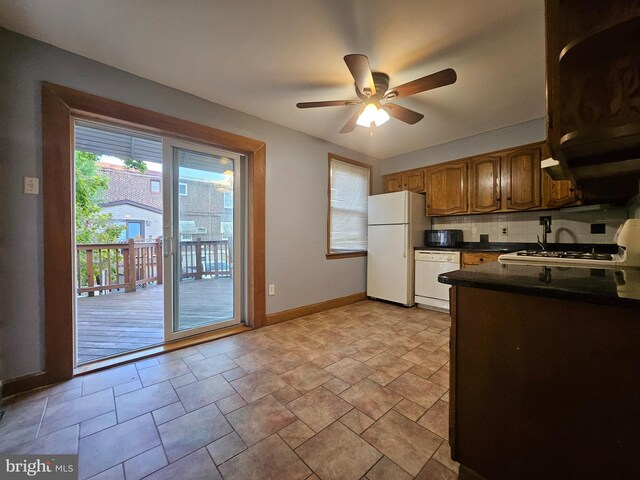 kitchen featuring light tile patterned floors, backsplash, white appliances, and ceiling fan