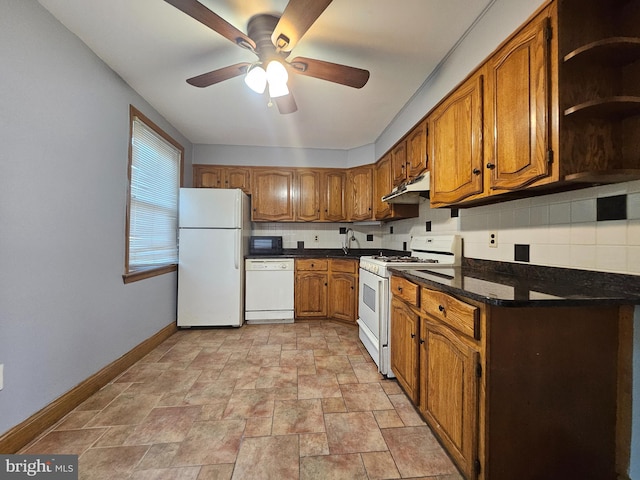 kitchen with white appliances, light tile patterned floors, dark stone counters, ceiling fan, and decorative backsplash