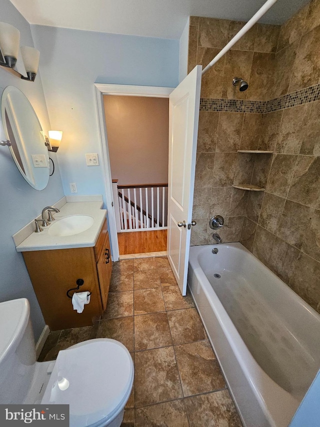 full bathroom featuring vanity, tiled shower / bath combo, toilet, and hardwood / wood-style flooring