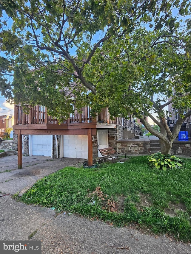 view of front of property with a garage and a deck