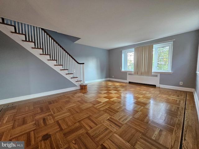 interior space with radiator and parquet floors