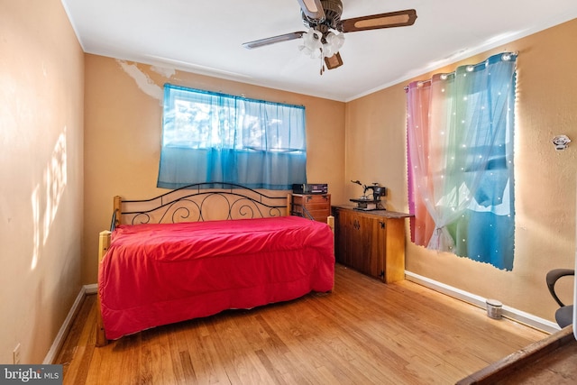 bedroom featuring hardwood / wood-style flooring and ceiling fan