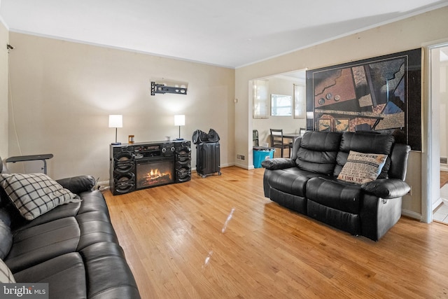 living room with crown molding and hardwood / wood-style flooring