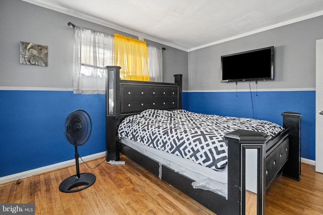 bedroom featuring hardwood / wood-style flooring and ornamental molding