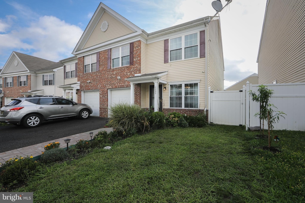 view of front of home with aphalt driveway, brick siding, an attached garage, a front yard, and fence