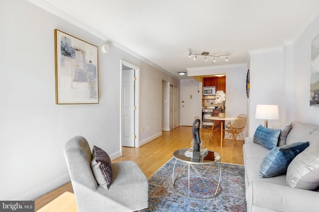 living room with ornamental molding and light hardwood / wood-style flooring