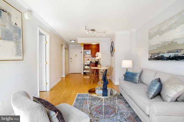 living room with ornamental molding and light wood-type flooring