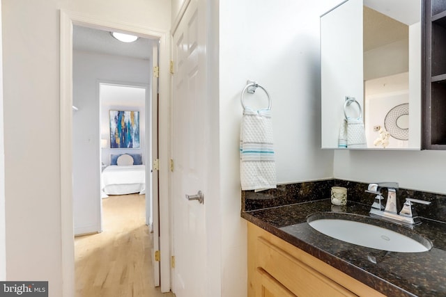 bathroom with vanity and hardwood / wood-style flooring