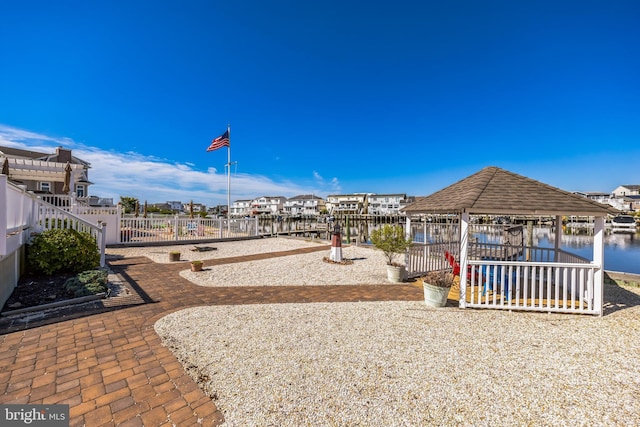 exterior space featuring a gazebo and a water view