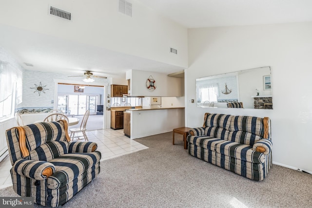 carpeted living room featuring ceiling fan and high vaulted ceiling