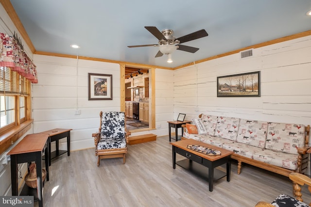 living room with ceiling fan and light hardwood / wood-style floors