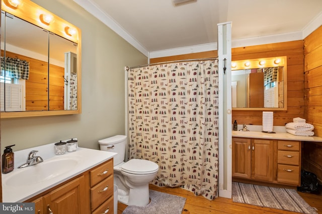 bathroom with toilet, ornamental molding, curtained shower, wood finished floors, and vanity