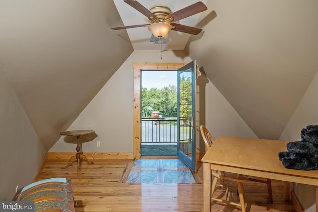 interior space with ceiling fan, lofted ceiling, and light hardwood / wood-style floors