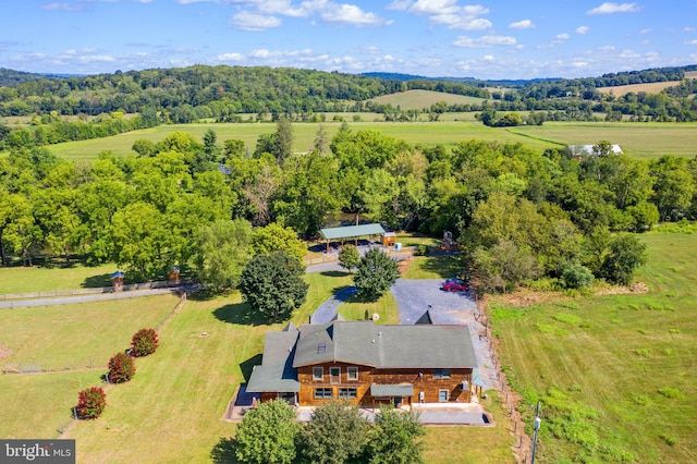 birds eye view of property with a rural view and a wooded view