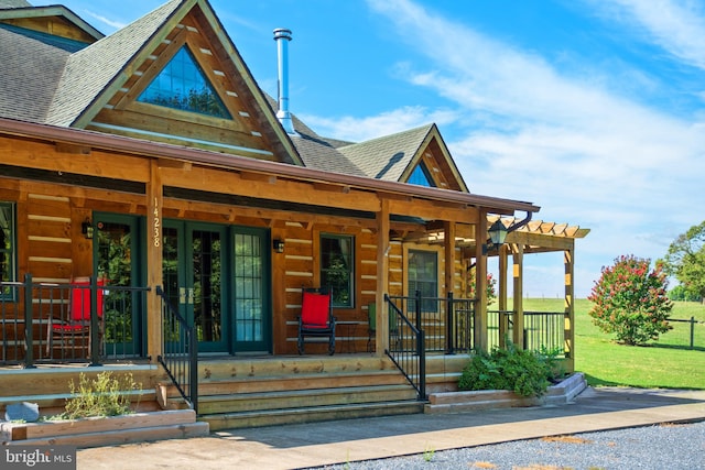 log-style house with a front lawn, covered porch, and a pergola