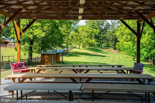 view of property's community with an outbuilding and a yard