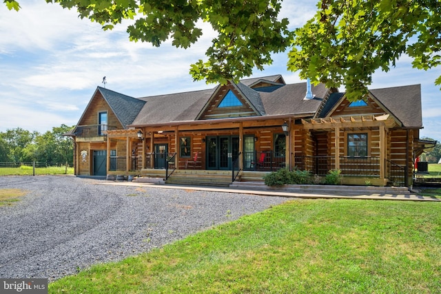 log home with a porch, french doors, gravel driveway, and a front lawn