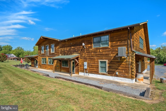 rear view of property with a lawn and central AC