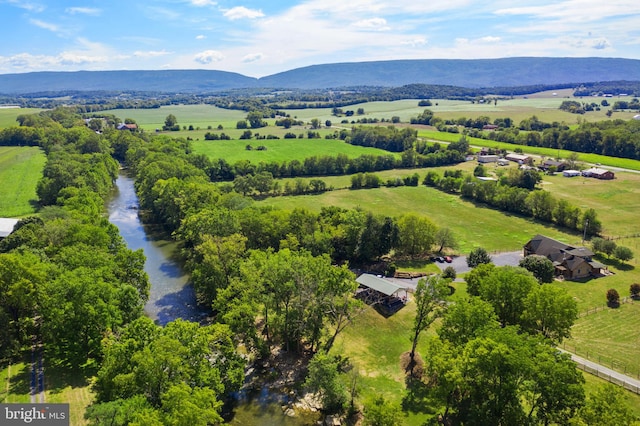 drone / aerial view featuring a water and mountain view and a rural view