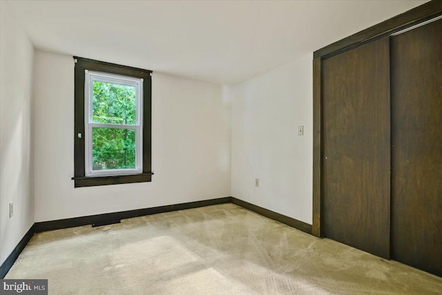 unfurnished bedroom with light colored carpet