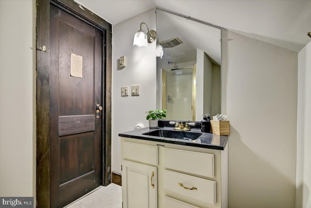 bathroom featuring tile patterned flooring, vanity, walk in shower, and vaulted ceiling