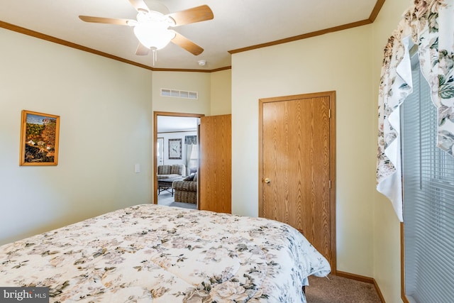 carpeted bedroom featuring ceiling fan and crown molding