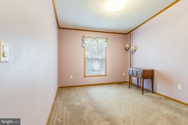 carpeted empty room with a textured ceiling and ornamental molding