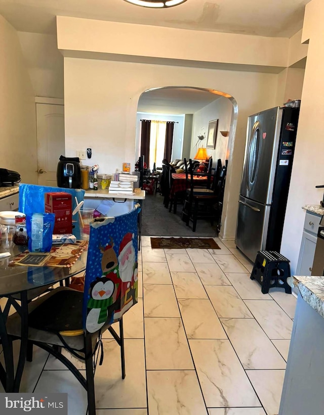 kitchen with stainless steel refrigerator and light tile patterned floors