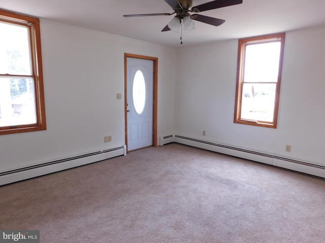 foyer entrance with a baseboard heating unit, ceiling fan, and light carpet