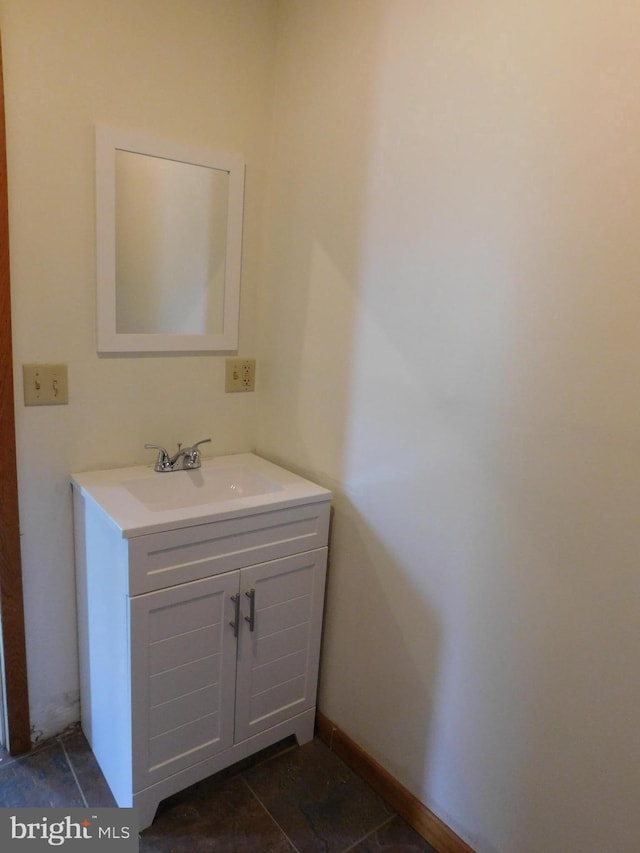 bathroom featuring baseboards and vanity