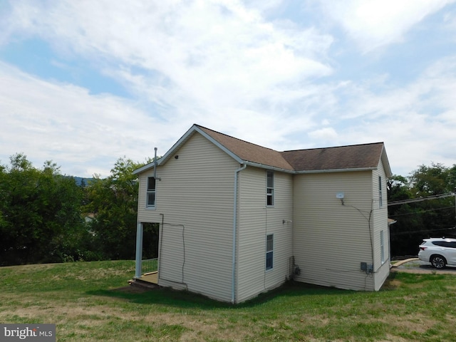 view of property exterior with a yard