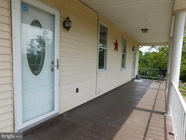 view of exterior entry with covered porch